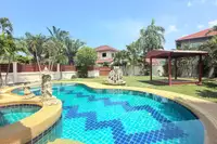 3 Bedroom House for Sale at Mike Orchid Villas 2, curved swimming pool with blue tiles and a garden gazebo.