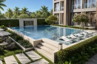 Level Pratumnak outdoor swimming pool with waterfall feature, in-pool sun loungers and lush tropical landscaping