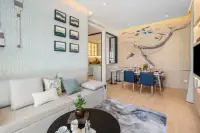 2 Bedroom Condo for Sale at Once Wong Amat open-plan living and dining area with whale mural accent wall and blue chairs