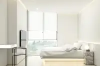 2 Bedroom Condo for Sale at Secret Garden Condominium, bedroom with large window, bed, and desk area.