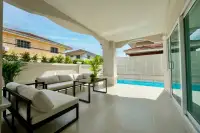 4 Bedroom House for Sale at Wonderland II covered poolside terrace with cream outdoor sofa set and tiled floor