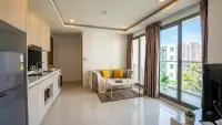 2 Bedroom Condo for Sale at Arcadia Beach Resort living area with balcony access and tropical view