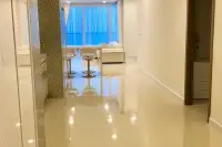 3 Bedroom Condo for Sale at Del Mare glossy marble-tiled hallway with mosaic accent wall leading to bright living area