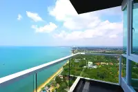 1 Bedroom Condo for Sale at Del Mare high-floor balcony with panoramic sea view over Pattaya coastline and lush greenery