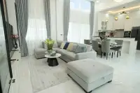 4 Bedroom House for Sale in Nong Prue open-plan living and dining area with double-height ceilings and modern kitchen