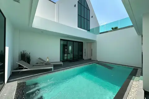 3 Bedroom House for Sale at Larelana Villa private courtyard with swimming pool and two lounge chairs.