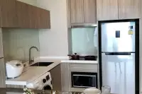 1 Bedroom Condo for Sale at Cetus Beachfront fully equipped kitchen with wood cabinets, stainless fridge and washing machine