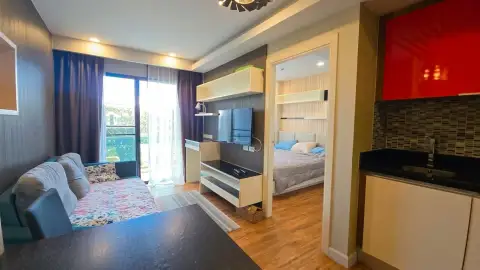 1 Bedroom Condo for Sale at Dusit Grand Park 1 living area with TV unit opening to bedroom and kitchenette