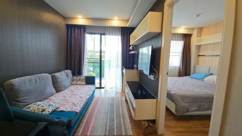 1 Bedroom Condo for Sale at Dusit Grand Park 1 living room sofa and balcony with view into bedroom