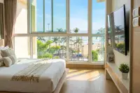 2 Bedroom Condo for Sale at Cetus Beachfront bright master bedroom with floor-to-ceiling windows overlooking beach and sea