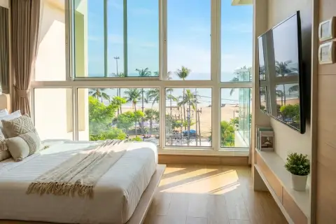 2 Bedroom Condo for Sale at Cetus Beachfront bright master bedroom with floor-to-ceiling windows overlooking beach and sea