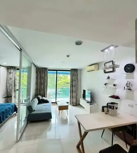 1 Bedroom Condo for Rent at Acqua Condo living area with glass partition opening to bedroom