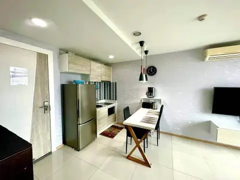 1 Bedroom Condo for Sale at Acqua Condo outdoor lagoon pool with palm trees and loungers
