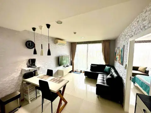 1 Bedroom Condo for Sale at Acqua Condo kitchenette with fridge, dining table and wall clock