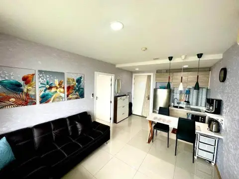 1 Bedroom Condo for Sale at Acqua Condo bedroom with teal bedding and abstract wall art