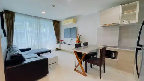 2 Bedroom Condo for Sale at Acqua Condo open-plan living room with sofa, dining table, and kitchenette