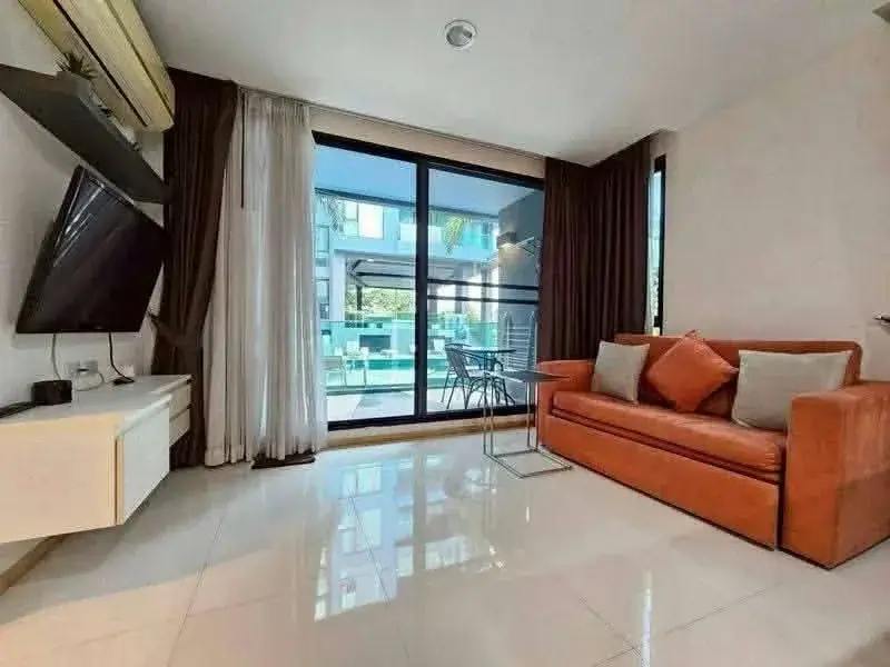 1 Bedroom Condo for Rent at Acqua Condo living room with orange leather sofa and balcony pool view