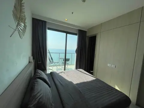 1 Bedroom Condo for Rent at Aeras bedroom with king bed, wardrobe, and private balcony overlooking the sea