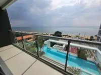 1 Bedroom Condo for Sale at Aeras balcony view of infinity pool and beachfront coastline