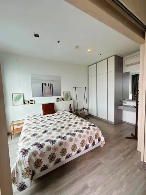 1 Bedroom Condo for Rent at Aeras bedroom with wardrobe, dressing area, and wall art