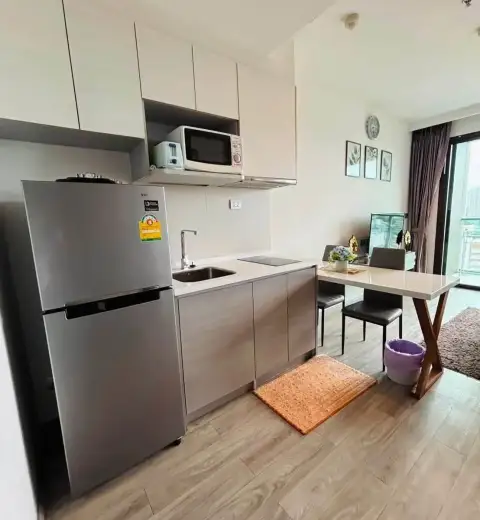 1 Bedroom Condo for Rent at Aeras kitchenette with refrigerator, microwave, and dining table