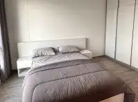 1 Bedroom Condo for Sale at Aeras bedroom with double bed, nightstands and built-in wardrobe