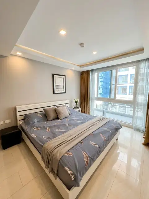 1 Bedroom Condo for Sale at Grand Avenue Residence bright bedroom with king bed and balcony window