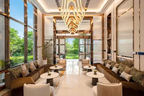 Once Pattaya luxurious lobby lounge area with stylish seating, marble floors, and a unique chandelier.