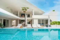 8 Bedroom House for Sale in Huai Yai large outdoor pool with sunloungers and modern white two-storey villa facade
