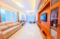 6 Bedroom House for Sale & Rent at Amorn Village, bright living area with sofas, dining table, and large windows.