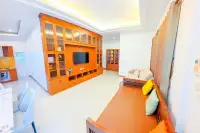 6 Bedroom House for Sale & Rent at Amorn Village, kitchen with wooden cabinets, yellow tiled backsplash, and appliances.