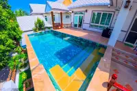 6 Bedroom House for Sale & Rent at Amorn Village, living room with large wooden entertainment unit and sofa.