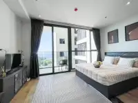 Studio Condo for Rent at Andromeda Condominium bedroom with king bed, balcony, and sea view