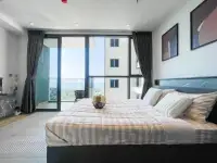 Studio Condo for Rent at Andromeda Condominium bed with ocean view through floor-to-ceiling windows
