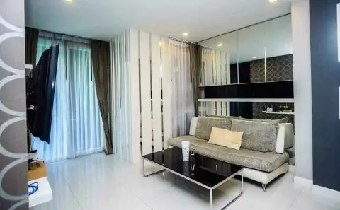 1 Bedroom Condo for Sale at Apus living room with beige sofa, glass coffee table and sheer curtains