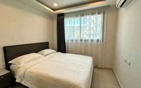 2 Bedroom Condo for Sale at Arcadia Beach Continental bedroom with double bed, sheer curtains and city view window