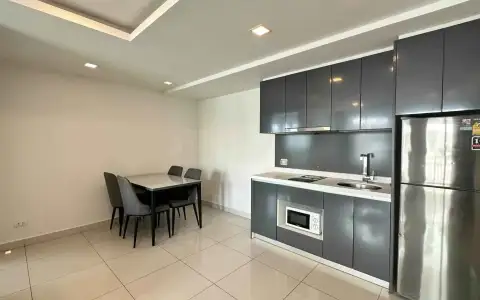 2 Bedroom Condo for Sale at Arcadia Beach Continental open-plan kitchen with gray cabinetry, stainless fridge and dining table