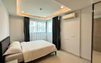 2 Bedroom Condo for Sale at Arcadia Beach Continental second bedroom with double bed, wall-mounted AC and large window