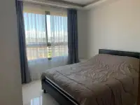 2 Bedroom Condo for Rent at Arcadia Beach Resort bedroom with double bed and city skyline view