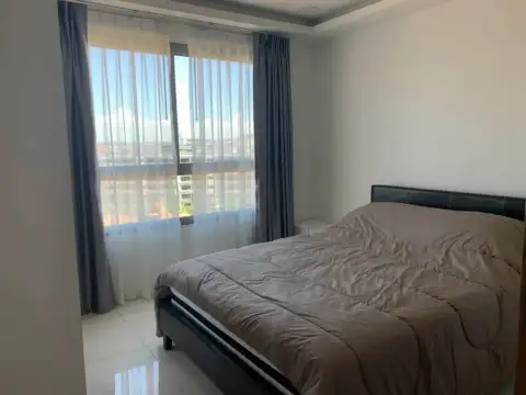 2 Bedroom Condo for Rent at Arcadia Beach Resort bedroom with double bed and city skyline view