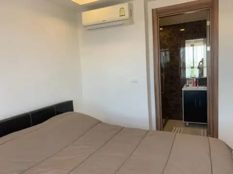 2 Bedroom Condo for Rent at Arcadia Beach Resort bedroom with air conditioning and en-suite bathroom entrance