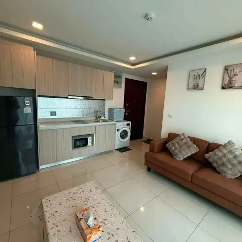 2 Bedroom Condo for Rent at Arcadia Beach Resort open kitchen with fridge, washer and adjoining living area