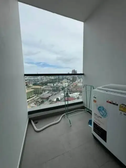 1 Bedroom Condo for Sale at Arcadia Millennium Tower balcony with city skyline view and washing machine