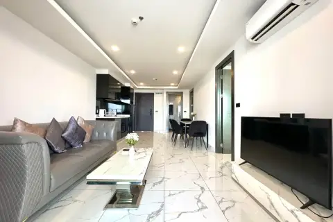 2 Bedroom Condo for Rent at Arcadia Millennium Tower open-plan living area with dining table, sofa and mounted TV
