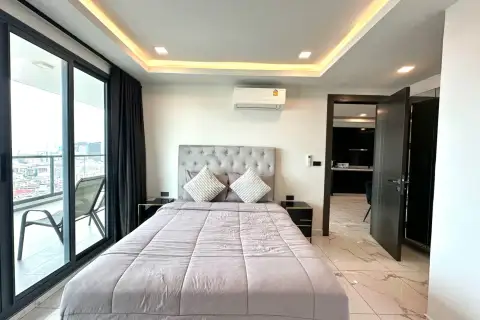 2 Bedroom Condo for Rent at Arcadia Millennium Tower bedroom with tufted headboard and balcony city view