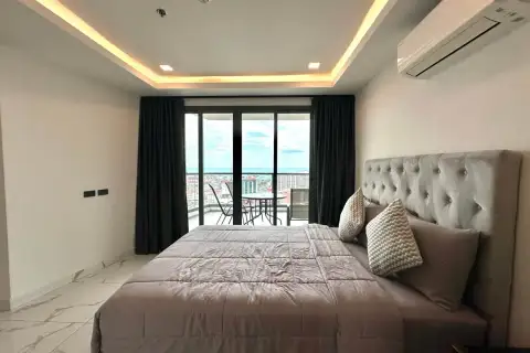 2 Bedroom Condo for Rent at Arcadia Millennium Tower bedroom with ocean view through balcony sliding doors
