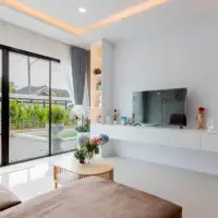 3 Bedroom House for Sale in East Pattaya bright living room with TV unit and garden view through glass doors