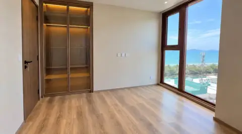 2 Bedroom Condo for Sale at Arom Jomtien bedroom with built-in glass wardrobe and sea view window