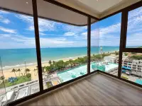 2 Bedroom Condo for Sale at Arom Jomtien corner room with wraparound windows showing beachfront and city skyline