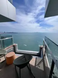 1 Bedroom Condo for Sale at Arom Wongamat private balcony with panoramic sea view and seating area